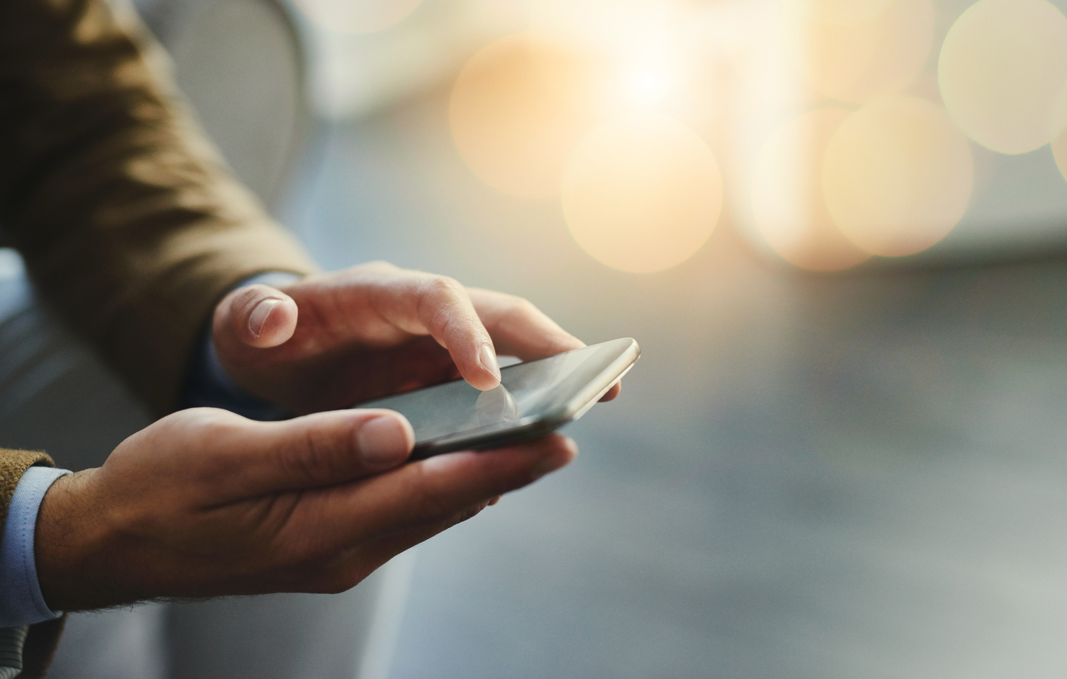 High angle shot of an unrecognisable man using a smartphone